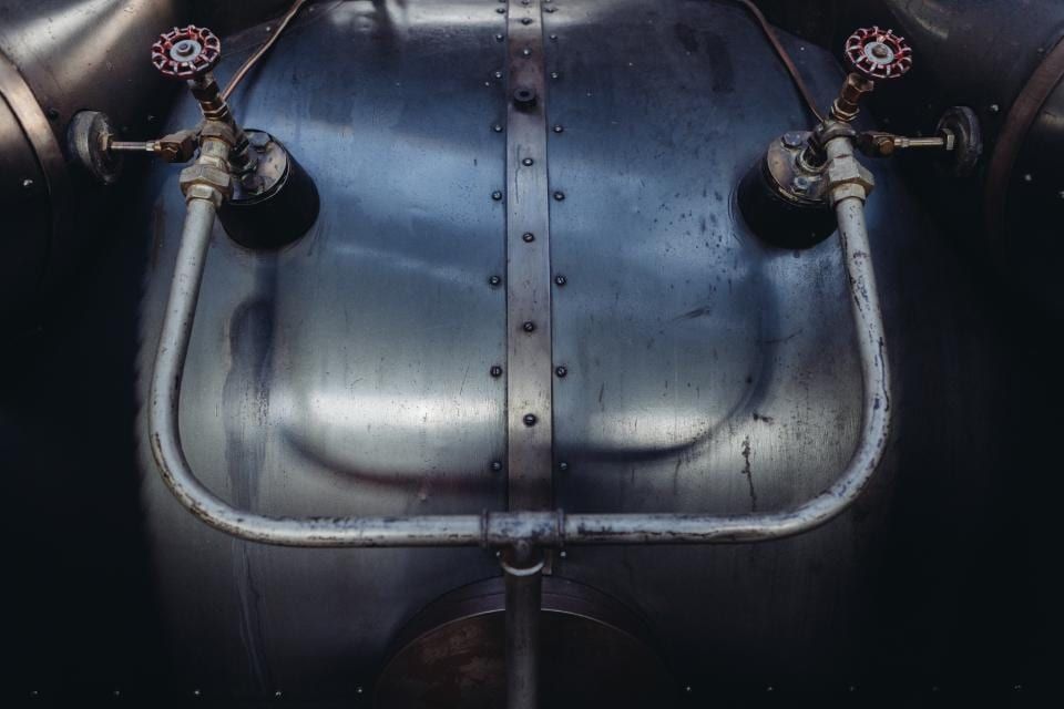Valves and copper pipework on a steel tank